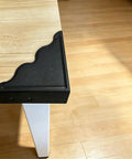 Keep Your Walls Pristine With These Tough Black Metal Corner Protectors Featuring Rust Resistant Build And Slick Smooth Edges For 3.7 Inch Wall Edge Shield Four Pack on wooden table edge.