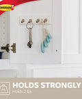 Quartz Key Rail For Damage Free Wall Organization No Drill Mount Includes One Rail Six Adhesive Strips Holds Up To Two Pounds Keeps Your Keys Neat And Clutter Free showing keys on cabinet door