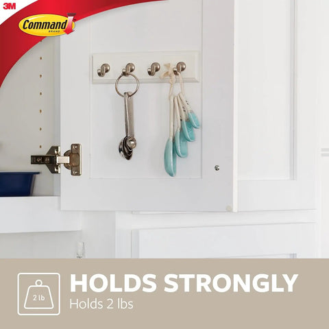 Quartz Key Rail For Damage Free Wall Organization No Drill Mount Includes One Rail Six Adhesive Strips Holds Up To Two Pounds Keeps Your Keys Neat And Clutter Free showing keys on cabinet door