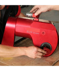 Man operating Professional Hydraulic Torque Wrench 36992 Nm with swivel couplers and adjustable handles.