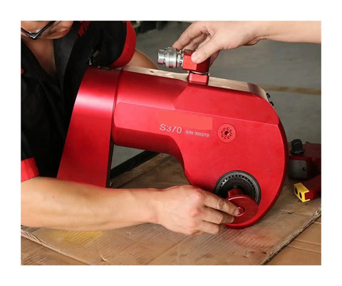 Man operating Professional Hydraulic Torque Wrench 36992 Nm with swivel couplers and adjustable handles.