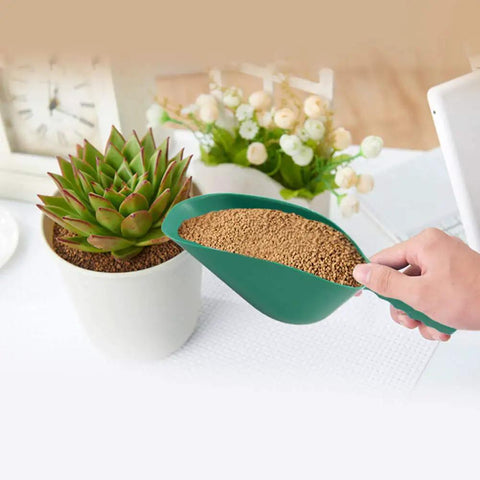 Person using All-Purpose Plastic Garden Soil Scoop Shovel, Lightweight Portable Digging Tool for Easy Planting beside a potted plant