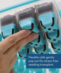 Close-up of hand pressing silicone cell in 36 Cell Reusable Seed Starter Tray For Easy Indoor Seed Starting Of Vegetables Flowers And Herbs