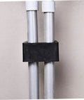 Close-up of black clip securing metal bars, part of 10 Pack Garden Furniture Clips For Wicker And Rattan Chairs, Outdoor Sofa Fasteners.