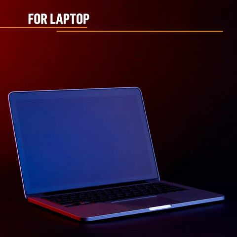 Laptop computer with blue screen on dark background lit by red and blue lighting.