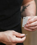 Person holding a bracket from a Straight Brackets Set For Wood Furniture Repair, 48 Pieces Stainless Steel 1.1mm Thick Flat Plate Brackets With 5mm Holes