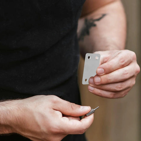 Person holding a bracket from a Straight Brackets Set For Wood Furniture Repair, 48 Pieces Stainless Steel 1.1mm Thick Flat Plate Brackets With 5mm Holes