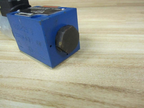 Close-up of Solenoid Directional Spool Valve 4WE6D62/EG24N9K33L/62 PN R978020512 Size 6 on wooden surface