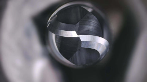Ball-nose carbide end mill, 1/8 in shank, metal finish, close-up inside a tool chuck