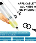 Hand holding Power Steering Fluid Extractor Kit For Cars 200cc Manual Oil Sucker Pump with dual hoses on white background.