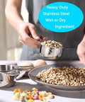 Person using 20 Piece Measuring Cups And Spoons Set For Cooking And Baking Gadgets Includes 7 Stainless Steel Cups 6 Spoons 3 Plastic Liquid Cups A Leveler And Easy Conversion Tool For Pro Grade Accurate Recipes