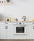 Modern kitchen with matte black kitchen cabinet handles set of 10, 4-3/4 inch length, 3-3/4 inch hole centers on white cabinets.