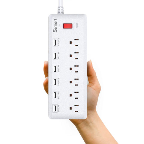 Person holding Six Outlet Surge Protector Power Strip With Six USB Ports And Six Foot Heavy Duty Extension Cord for home use.