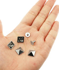 30 Pack Of 10mm Square Tip Zinc Alloy Screw Rivets In Sleek White Nickel Finish, displayed in a hand, showcasing different rivet shapes.