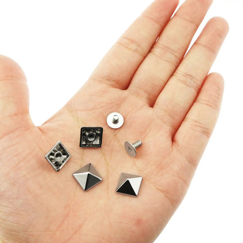 30 Pack Of 10mm Square Tip Zinc Alloy Screw Rivets In Sleek White Nickel Finish, displayed in a hand, showcasing different rivet shapes.