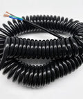 Heavy Duty Three Core Telescopic Extension Cord Self Retracting Power Cable with Beefy Protective Jacket coiled for easy storage.