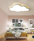 Cloud Shape LED Ceiling Light For Kids Room Acrylic Flush Mount Chandelier With Remote Dimmable Warm And White Light Large 25.5 Inch By 16 Inch Kids Bedroom Nursery Living Room Decor in a modern bedroom setting above a bed