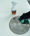 Hand applying Straight Up Super Legit Woodworking Saw Blade Cleaner That Nukes Pitch Adhesive Residue And Gum Buildup to circular saw blade.