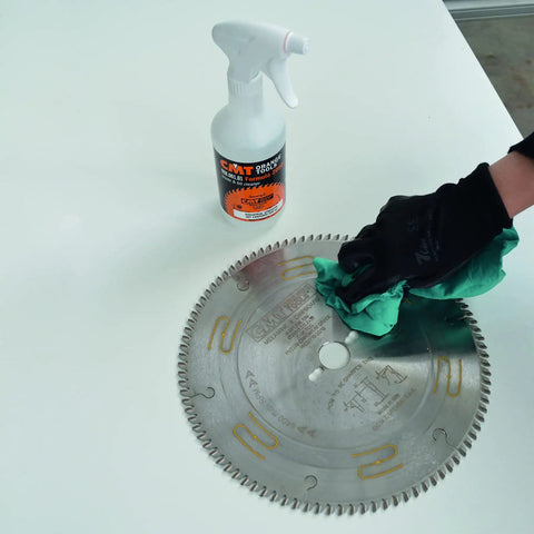Hand applying Straight Up Super Legit Woodworking Saw Blade Cleaner That Nukes Pitch Adhesive Residue And Gum Buildup to circular saw blade.