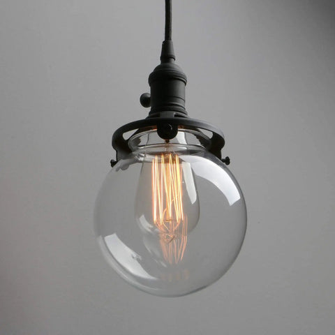 Three Light Industrial Cluster Pendant Ceiling Fixture With 5.9 Inch Clear Globe Shades In Black Finish showing a single globe