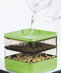 Water being poured into a Two Tier Seed Sprouter Kit With Lid For Indoor Germination And Microgreens Grow Trays, soil-free system.