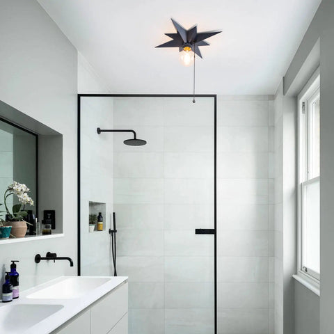 Black Star Flush Mount Ceiling Light With Pull Chain On Off Switch in modern bathroom setting, mid-century style, black finish.