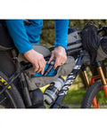 Cyclist accessing tool in Green 4.5L Bike Frame Bag With Water Resistant Poly Nylon Build Easy Access Pocket Secure Hook And Loop Mounting