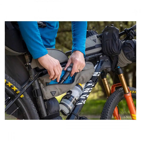 Cyclist accessing tool in Green 4.5L Bike Frame Bag With Water Resistant Poly Nylon Build Easy Access Pocket Secure Hook And Loop Mounting