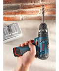 Person using Ultra Compact 12V Max Hammer Drill And Driver Kit with 3/8 Inch Auto Chuck on brick wall, showcasing two speed control
