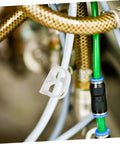 Adjustable Flow Control Tube Clips For 1/4 And 5/16 Inch Hoses shown in use on flexible tubing among wires and hoses