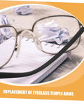 Front close-up view of eyeglasses with metal temple replacement arms on a notebook. Two Pairs Metal Eyeglass Temple Replacement Arms Kit For Fast Easy Repairs Ergonomic Durable Design For All Day Comfort Sturdy Construction Fits Standard Frames Quick Fix For Glasses.