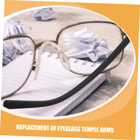 Front close-up view of eyeglasses with metal temple replacement arms on a notebook. Two Pairs Metal Eyeglass Temple Replacement Arms Kit For Fast Easy Repairs Ergonomic Durable Design For All Day Comfort Sturdy Construction Fits Standard Frames Quick Fix For Glasses.