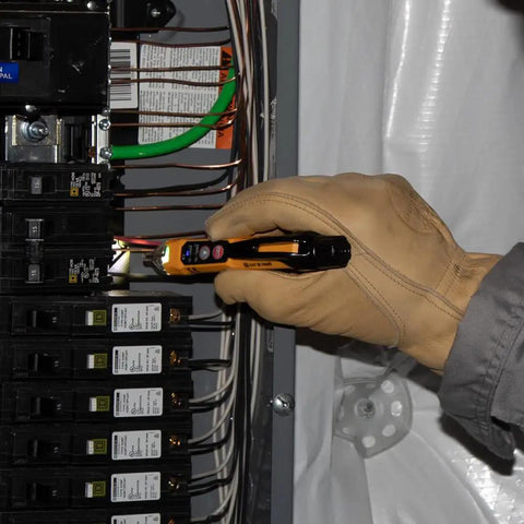 Technician using HVAC Pro Kit With Digital Clamp Meter Dual IR And Probe Thermometer And Dual Range Non Contact Voltage Tester With Flashlight on wiring panel