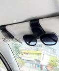 Keep Your Ride Looking Sharp With This Two Pack Magnetic Sunglass Holder Upgrading Leather Visor Clip holding glasses in car.