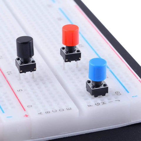 84 Pcs Momentary Tactile Push Button Switch Kit 6x6x8mm With 7 Color Button Caps Black Red Blue Yellow White Green Gray 12 Pieces Each For Breadboard Arduino Prototyping And DIY Electronics Projects showing black, red, and blue switches on breadboard
