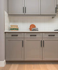 Matte Black 7.38 Inch Cabinet Pulls 30 Pack Stainless Steel Kitchen Cupboard Handles installed on modern gray cabinets.