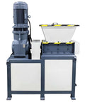 Industrial biaxial shredder machine with top hopper and blue-gray body.