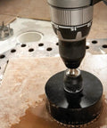 Heavy Duty 11 Piece Diamond Hole Saw Assorted Set For Concrete And Tile with a drill in action on a tile surface.