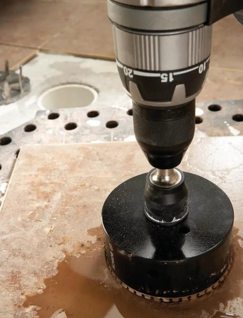 Heavy Duty 11 Piece Diamond Hole Saw Assorted Set For Concrete And Tile with a drill in action on a tile surface.