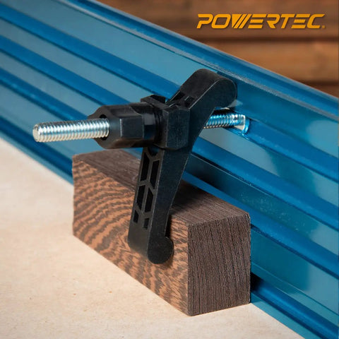 T Track Hold Down Clamp Kit With 5/16 Inch 18 Thread T Bolts Thumbs Swivels 4 Pack For CNC Machines Table Saws Drills Workbenches And Woodworking Jigs clamp holding wood block on blue T-track