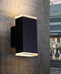 Ultra Sleek 9 Inch LED Rectangle Outdoor Wall Light In Aluminum, Matte Black Finish, mounted on wall, glowing