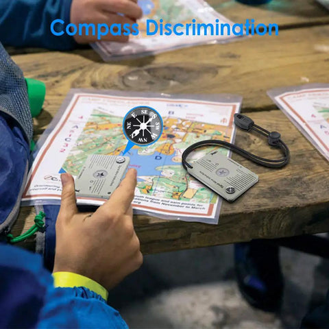 Military Grade Signal Mirror Survival Tool With Small Compass And Whistle used with map for navigation on wooden table