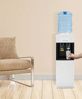 Standing Hot And Cold Water Cooler Dispenser With Top Loading On Demand 5 Gallon Bottle Compatible in a home setting.