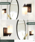 2 Pack Farmhouse Vanity Light Fixtures With One Light Each, Indoor Black Wall Sconce With Dual Glass Shades, mounted upwards and downwards in a room.