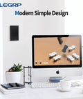 Glossy Black Decorator Receptacle Outlet 15A 125V on wall near modern computer setup in office space