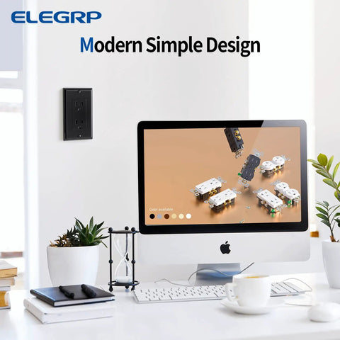 Glossy Black Decorator Receptacle Outlet 15A 125V on wall near modern computer setup in office space