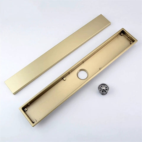 Slick Stainless Steel Linear Shower Drain With Built In Hair Catcher And Flush Grate Cover For Fast Water Flow, gold finish parts.
