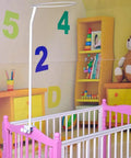 Hassle Free Universal Crib Canopy Holder Adjustable Metal Clamping Stand positioned over a pink crib for baby mosquito nets.