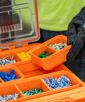 Worker holding orange MODBOX Replacement Bins Four Pack Rectangle and Square Bins for Short Component Boxes with screws inside