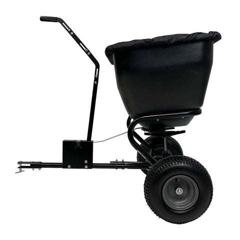 Side view of Deluxe Tow Behind Broadcast Spreader with Extended Easy Reach Handle and Weatherproof Cover, 175 lb capacity.